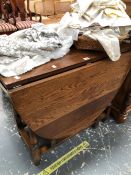 A MODERN OAK OVAL FLAP TOP TABLE ON SQUARE SECTION AND BALUSTER LEGS WITH BUN FEET. W 45 CLOSED x