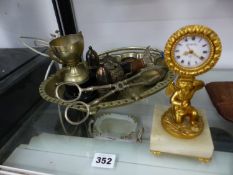 A CLOCK SUPPORTED BY A GILT CUPID TOGETHER WITH A SELECTION OF ELECTROPLATE