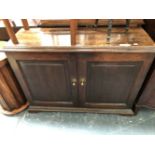 A 19th C. OAK SIDE CABINET, THE TWO PANELLED DOORS ENCLOSING SHELVES. W 112 x D 37 x H 83cms.
