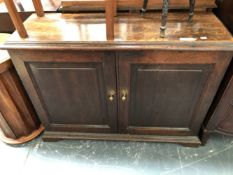 A 19th C. OAK SIDE CABINET, THE TWO PANELLED DOORS ENCLOSING SHELVES. W 112 x D 37 x H 83cms.