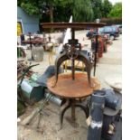 A PAIR OF INDUSTRIAL STYLE ADJUSTABLE CIRCULAR TOP TABLES ON STEEL TRIPOD LEGS