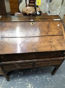 AN 18th C. OAK BUREAU, THE TOP REMOVABLE FROM A TWO DRAWER STAND WITH PIERCED BRACKETS AT THE TOPS