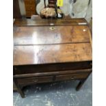 AN 18th C. OAK BUREAU, THE TOP REMOVABLE FROM A TWO DRAWER STAND WITH PIERCED BRACKETS AT THE TOPS