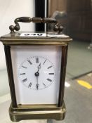 A FRENCH CARRIAGE CLOCK STRIKING THE HOURS ON A BELL