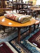 A VICTORIAN MAHOGANY CIRCULAR FLAP TOP TABLE ON FOUR REEDED CYLINDRICAL LEGS TAPERING TO WHITE