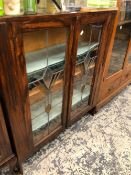 A 20th C. OAK DISPLAY CABINET, THE LEADED COLOURED GLASS DOORS ENCLOSING FOUR SHELVES. W 90 x D 25 x