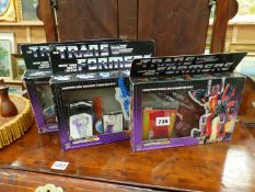 THREE VINTAGE BOXED TRANSFORMERS FIGURES INCLUDING STARSCREAM, SCOURGE, AND THRUST.