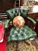 A MODERN GREEN LEATHERETTE BUTTON UPHOLSTERED MAHOGANY DESK CHAIR ROTATING ON FIVE LEGS WITH