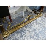 A VICTORIAN BRASS FIRE KERB WITH TUBULAR IRON FIRE IRON RESTS AT EACH END. W 140cms. AND TWO OTHERS