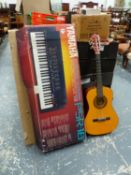 A YAMAHA ELECTRONIC KEYBOARD, AND A GUITAR.