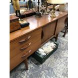 AN AVALON TEAK SIDEBOARD WITH THREE DRAWERS FLANKING A CUPBOARD WITH TWO SLIDING DOORS ABOVE