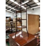 A SATIN WOOD BANDED CAKE STAND WITH THREE DISHED CIRCULAR TIERS