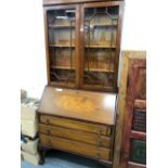 A 20th C. MAHOGANY BUREAU BOOK CASE, THE UPPER HALF GLAZED, THE FALL ABOVE THREE GRADED DRAWERS