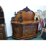 A VICTORIAN MAHOGANY CHIFFONIERE, THE FOLIAGE CRESTING FLANKED BY HALF BALUSTER URNS, THE BASE