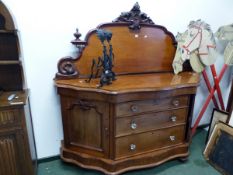 A VICTORIAN MAHOGANY CHIFFONIERE, THE FOLIAGE CRESTING FLANKED BY HALF BALUSTER URNS, THE BASE