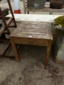 A SMALL COTSWOLD TEAK PATIO TABLE