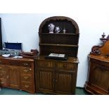 A 20th C. OAK DRESSER, THE TWO SHELF ENCLOSED BACK WITH A ROUND TOP, THE BASE WITH TWO FLUTED