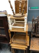 A 20th C. NEST OF THREE OAK TABLES, TWO RUSH SEATED STOOLS AND ANOTHER STOOL WITH A PINE CIRCULAR