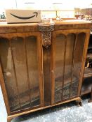 AN ARTS AND CRAFTS OAK BUREAU TOPPED OPEN SHELF BOOK CASE TOGETHER WITH A 1940S WALNUT GLAZED