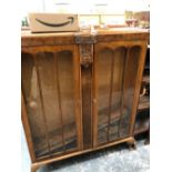 AN ARTS AND CRAFTS OAK BUREAU TOPPED OPEN SHELF BOOK CASE TOGETHER WITH A 1940S WALNUT GLAZED