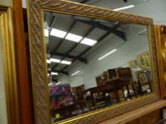 A LARGE ART NOUVEAU STYLE GILT FRAMED MIRROR.