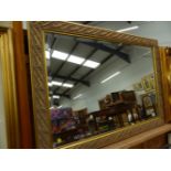 A LARGE ART NOUVEAU STYLE GILT FRAMED MIRROR.