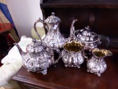 A SILVER PLATE FOUR PIECE TEA SET AND A FURTHER TEA POT.