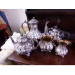 A SILVER PLATE FOUR PIECE TEA SET AND A FURTHER TEA POT.