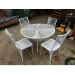 A PAINTED WROUGHT IRON BASKET WEAVE DESIGN PATIO TABLE AND FOUR MATCHING CHAIRS
