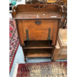 AN ARTS AND CRAFTS OAK BUREAU, THE FALL WITH IRON STRAP HINGES WITH A THREE QUARTER GALLERIED
