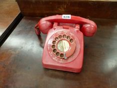 A VINTAGE RED TELEPHONE.
