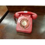 A VINTAGE RED TELEPHONE.