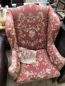 A WING ARMCHAIR UPHOLSTERED ON TERRACOTTA GROUND FLORAL DAMASK, THE CHANNELLED SQUARE FRONT LEGS