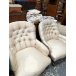 TWO SIMILAR VICTORIAN ARMCHAIRS WITH BUTTON UPHOLSTERED HOOP BACKS, THE TURNED MAHOGANY FRONT LEGS