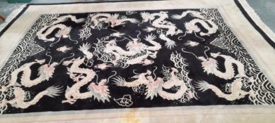 A CHINESE DRAGON DESIGN CARPET. 380 x 277cms