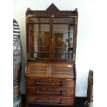 AN ARTS AND CRAFTS OAK BUREAU BOOKCASE, THE UPPER HALF WITH GLAZED DOORS. THE BASE WITH THE FALL
