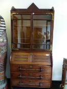 AN ARTS AND CRAFTS OAK BUREAU BOOKCASE, THE UPPER HALF WITH GLAZED DOORS. THE BASE WITH THE FALL