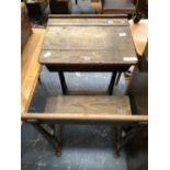 AN OAK SCHOOL DESK WITH LIDDED COMPARTMENT AND SEAT ON IRON SUPPORTS
