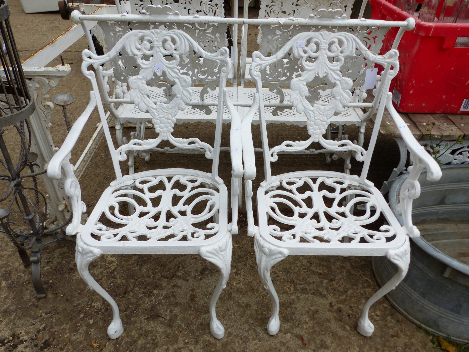 A PAIR OF PAINTED CAST IRON PATIO ARMCHAIRS