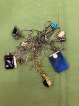 A COLLECTION OF SILVER PENDANTS AND CHAINS.