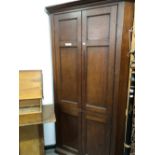 A 19th C. OAK CORNER CUPBOARD, THE UPPER HALF WITH DOORS OF TWO PANELS AND THE LOWER DOORS OF A