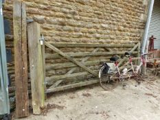 A LARGE TEAK DRIVEWAY GATE WITH POSTS