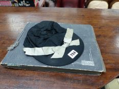 AN ANTIQUE SCRAP ALBUM AND A SILK JOCKEY CAP.