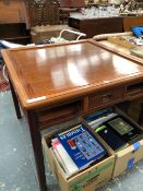 A CHINESE HARDWOOD TABLE THE REMOVABLE TOP OVER DRAWERS CENTRAL TO EACH SIDE AND FLANKED BY