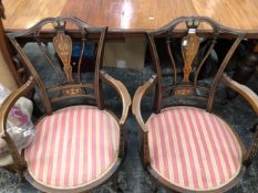 AN EDWARDIAN MARQUETRIED ROSEWOOD SUITE OF A SETTEE AND TWO ELBOW CHAIRS