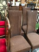 A SET OF FOUR LLOYD LOOM CHAIRS WITH TALL RECTANGULAR BACKS AND SUPPORTED ON CYLINDRICAL LEGS