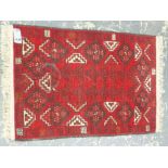 AN AFGHAN RUG. 124 x 184cms