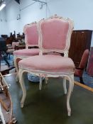 A PAIR OF ROCOCO TASTE PINK DETAILED CREAM PAINTED CHAIRS, THE UPHOLSTERED BACKS CRESTED BY