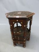 AN ISLAMIC HARDWOOD TABLE, THE HEXAGONAL TOP BLIND FRET CARVED WITH SCRIPT ABOUT MOTHER OF PEARL