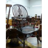 AN ANTIQUE WINDSOR WHEEL BACK ARM CHAIR.